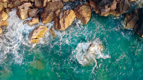 Blue Sea Beating Against High Cliffs. Aerial View.