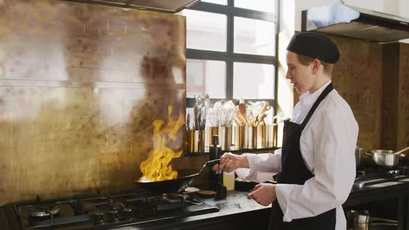 Chef cooking vegetables with fire