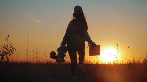 Little Girl in Dress Holding Teddy Bear Toy at Sunset. Silhouette of a Child with a Toy. Concept of