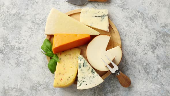 Various Types of Cheese Served on Rustic Wooden Board