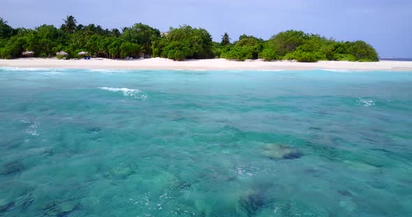 Tropical above island view of a sunshine white sandy paradise beach and turquoise sea background in 