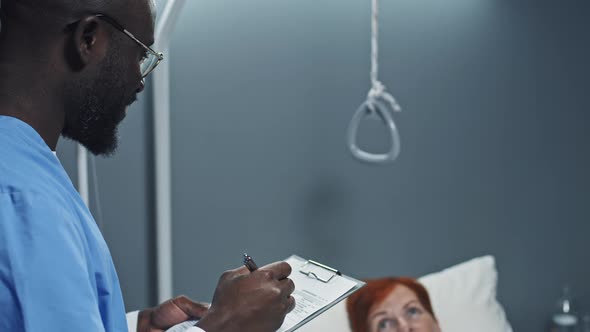 Nurse Filling in Medical Record of Patient