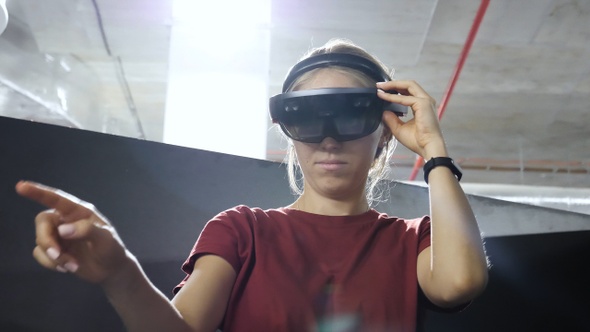 Woman working using VR headset.