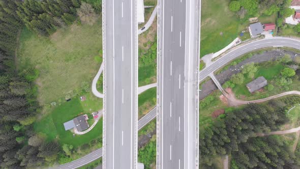 Aerial Top View of Highway Viaduct with Multilane Traffic in Mountains. Autobahn in Austria