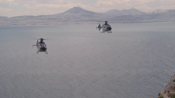 Aerial of Private Helicopters Flying Over the Ionian Sea and Towards Cliffs