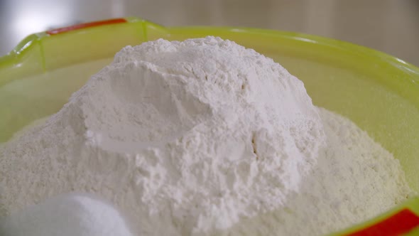 Pile of Flour in a Light Green Plastic Bowl in the Bakery