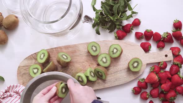 Step by step. Slicing fresh organic kiwi for infused water.