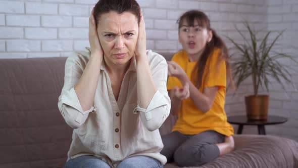 Quarrel with mother. A view of a child quarrel with her mother in the room. 