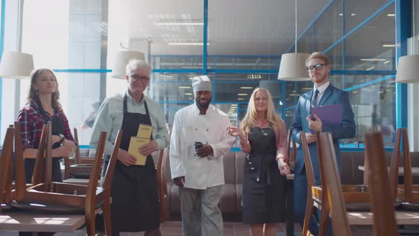 Happy Multiethnic Cafe Employees Smiling at Camera