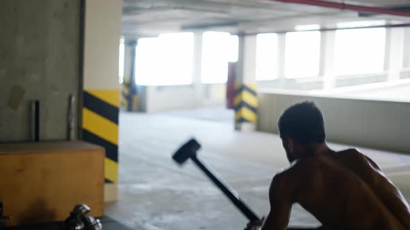 Athlete Hitting Huge Tire with Sledgehammer