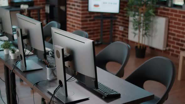 Empty Startup Office with Computers on Desk at Workstation