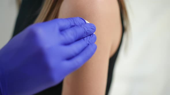 Closeup Applying Disinfectant on Female Hand Before Vaccination