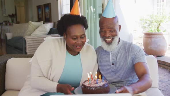 Happy senior african american couple wearing party hats