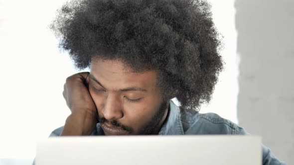 Close Up of Tired African Man Sleeping at Work