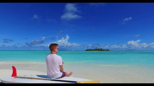 Romantic couple happy together on exotic tourist beach lifestyle by blue ocean with white sand backg