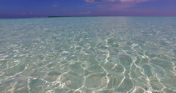 Tropical birds eye travel shot of a sunshine white sandy paradise beach and turquoise sea background