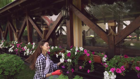 Girl in Rubber Gloves Cutting Plants with Garden Pruner