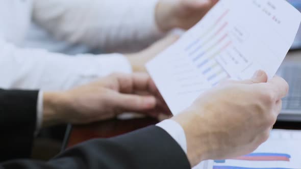 Male Boss Checking Report on Company Sales, Working Together With Employees