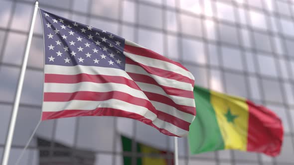 Waving Flags of the United States and Senegal in Front of a Skyscraper
