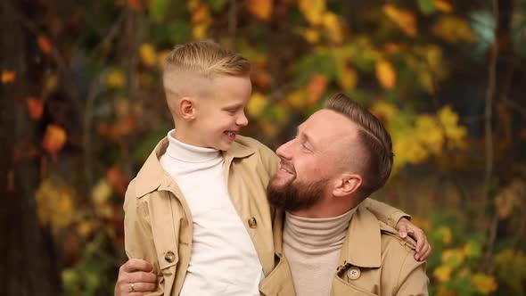 Dad and Son are Walking in the Park