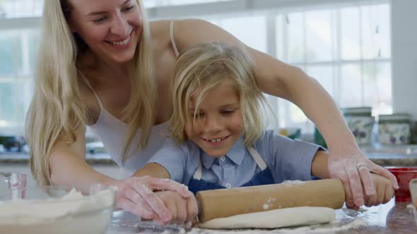 Mother and son making christmas cookies at home