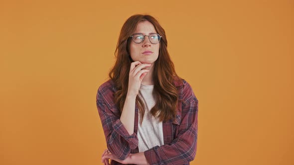 Redhaired Teenage Girl in Checkered Shirt and Glasses