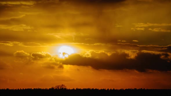 Sunset in the Sky Through Yellow Layered Clouds Timelapse