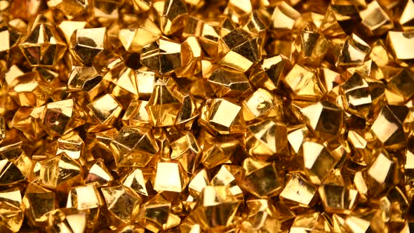 Abstract background of golden nuggets spinning