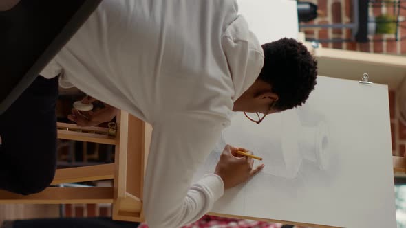 Vertical Video African American Student Using Pencil to Draw Vase Sketch alt