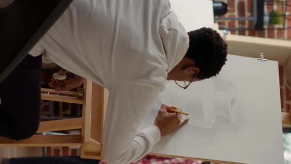 Vertical Video African American Student Using Pencil to Draw Vase Sketch