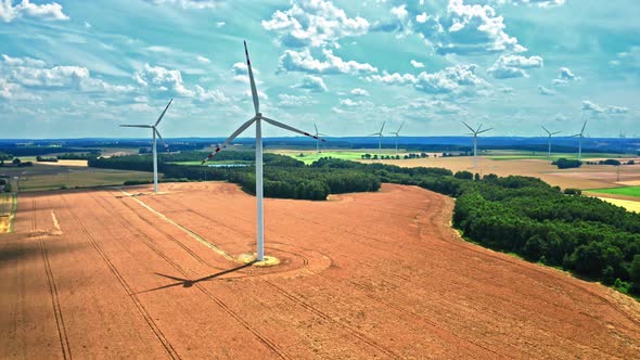 Wind turbines on brown field, aerial view