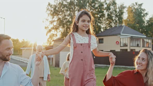 Parents Walking Daughter on Fencing