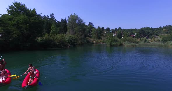 Aerial view of friends paddling canoe on river