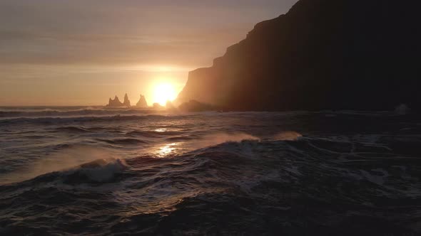 Drone Towards Reynisdrangar Sea Stacks At Sunset