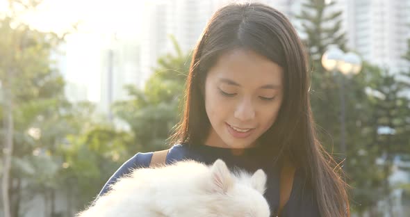 Woman with her Pomeranian dog at outdoor park