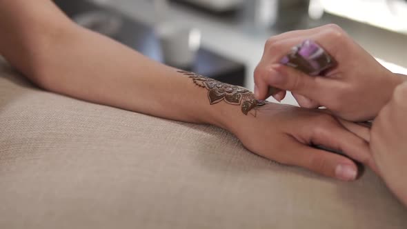 Doing Traditional Mehendi Drawings.