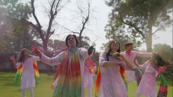 Indian couple throws colors in the air wishes Happy Holi