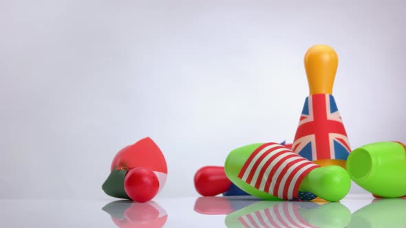 Various Countries Flags on Bowling Skittles and Ball with Inscription Crisis