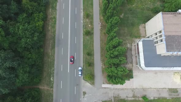 Aerial Shot of Red Convertible Car Riding Through Countryside Road
