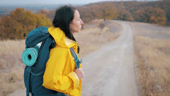 Woman Traveler with Backpack Walking in the Mountains, Freedom and Happiness. Active Sport Lifestyle