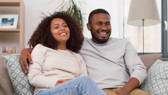 Happy African American Couple Hugging at Home