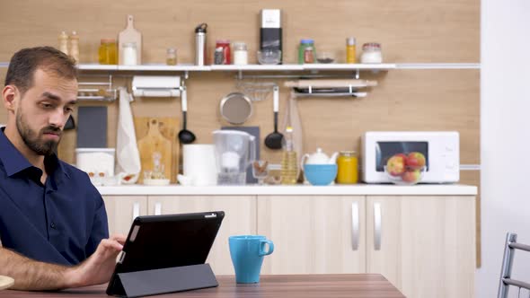 Man in the Kitchen Drinking Coffee