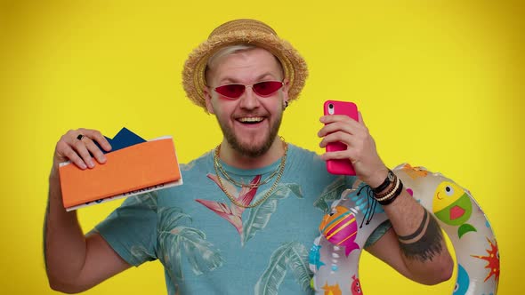 Bearded Man Tourist with Mobile Phone Celebrating Winning Holiday Resort Vacation Tickets Pass