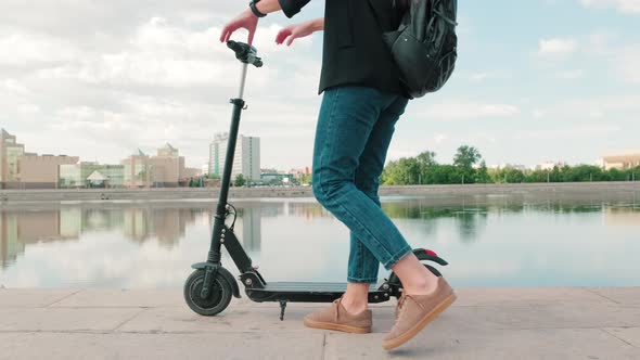 Unrecognizable Female Riding Electric Scooter