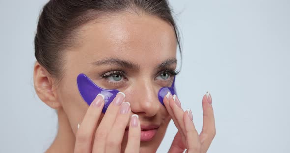 Close Up Portrait of Woman with Violet Eye Patche and Touching Her Face While Looking to Camera