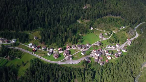 Mountain village at the Dolomite area in northern Italy with roads passing through buildings and hom