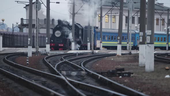 Steam Locomotive Train Approaching Station Passing Through a Goods Yard