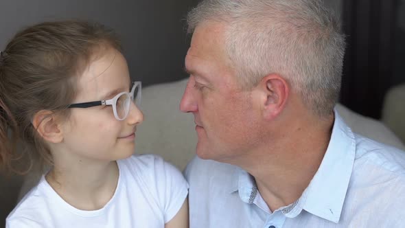 Handsome Father and Cute Daughter are Looking at Each Other Happy Family Togetherness Father's Day