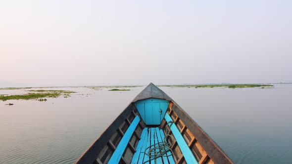 Old Blue Wooden Motor Boat Floats on the Calm River Water Surface Early Morning. Inle Lake, Myanmar