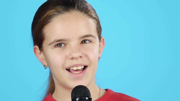 Close-up Little Female Singing with Microphone. Slow Motion